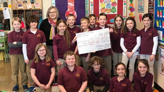 Shepherd of the Hills third-graders saved more than $450 to give to the Fondy Food Pantry. Left to right, back row, Joey Puetz; Killian Stoffel;  Fondy Food Pantry Board member Judy Cusic; Julia Fidziukiewicz; Nolan Condon; Devin Zook; Gabriel O'Brien; Leo Gnadt; Ellie Smith; Addison Gantner; Carly Masarik. Front row,  Megan Taylor, Reede Baker, Liam Huhn, Ava Smith and Riley Thorton.