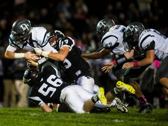 Dallastown ball carrier Michael Hernandez gets dragged