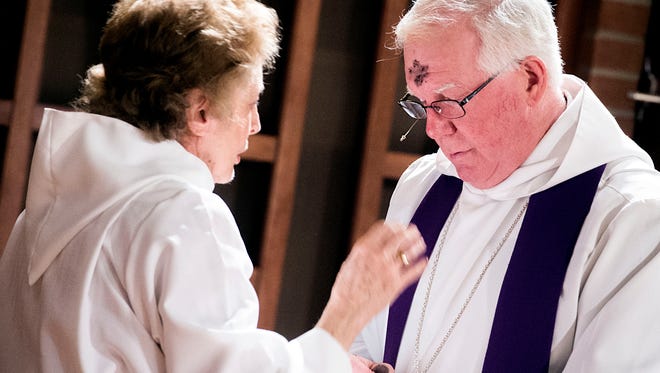 Rev. Dough Smith, right, of All Saints Episcopal Church in Hanover receives ashes from Sarah Terhune. Ash Wednesday is the start of Lent, which runs through Easter Sunday.