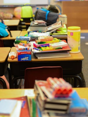 School supplies take over students' desks on the first day of school at Cache La Poudre Elementary School Monday, August 22, 2016.