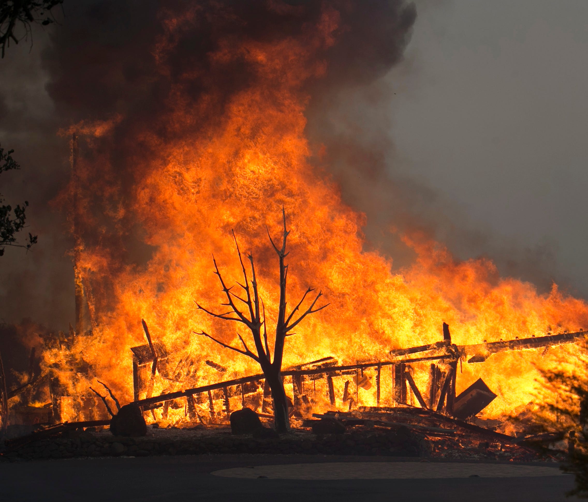 Flames from a wildfire consume a home  east of Napa, Calif. Oct. 9, 2017.