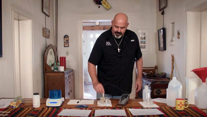 NMSU Chemical and Materials Engineering Department Head David Rockstraw demonstrates how to analyze salt concentrations in adobe samples in his 142-year-old adobe home in Mesilla.