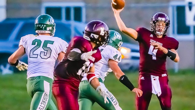 Eaton Rapids quarterbcak Zach Kemp, right, passes to Tristen Schultz, second from left, for a first down during a game against Williamston last year.  Kemp and Schultz are both returning for the Greyhounds' offense in 2016.