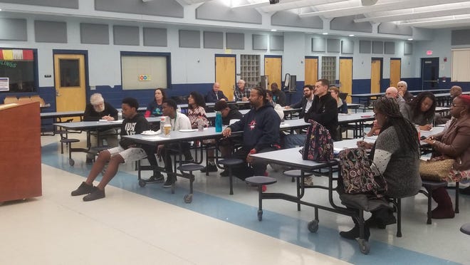 Participants in Gainesville For All listen to assistant Alachua County manager Carl Smart speak at a meeting at Rawlings Elementary School in February.