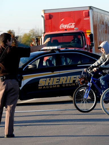 Macomb County Sheriff's Deputy Jon Ramlow stops traffic
