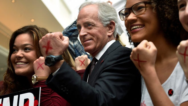 Sen. Bob Corker and others show the red X's on their hands in the effort to end human trafficking.