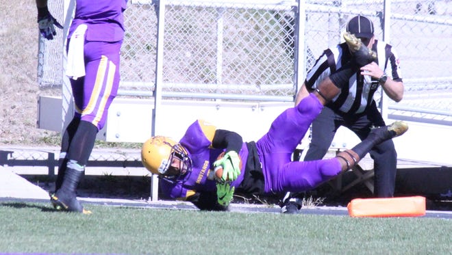 Marques Rodgers dives across the goal line for the first Western New Mexico University football score Saturday against Chadron.