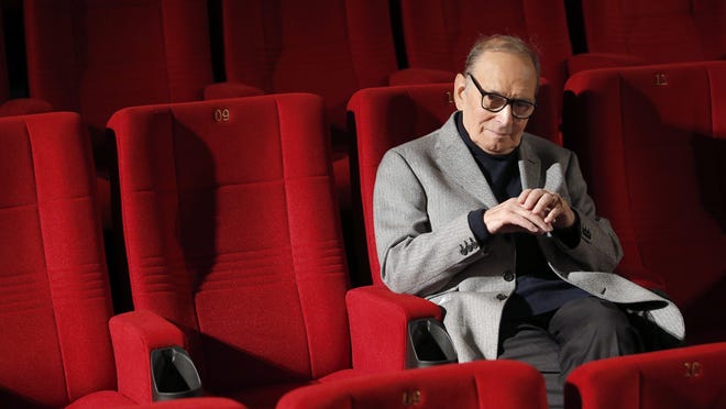 In this Dec. 6, 2013 file photo, Italian composer Ennio Morricone poses during a photo call to promote his German 2014 concerts, in Berlin, Germany.