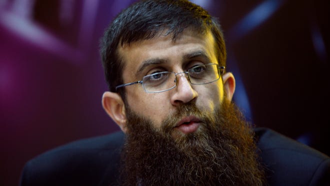In this May 6, 2012 file photo, Palestinian Khader Adnan, an Islamic Jihad spokesman who went on a 66-day hunger strike while he was imprisoned in an Israeli jail, speaks during a television interview in the West Bank city of Ramallah.