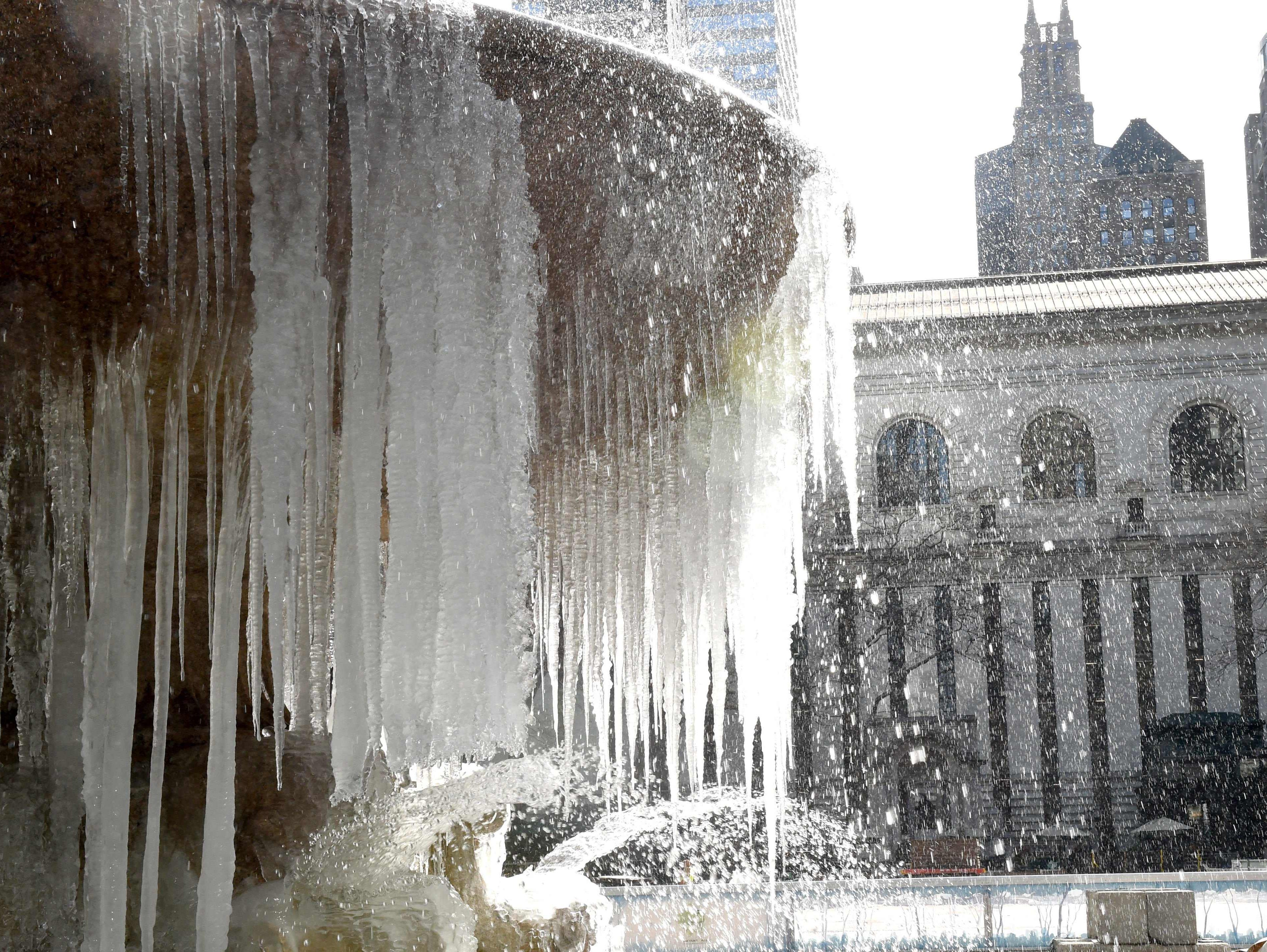 The Josephine Shaw Lowell Memorial Fountain in Bryant Park is covered in ice and snow as Winter Storm Stella pounds the East Coast.
