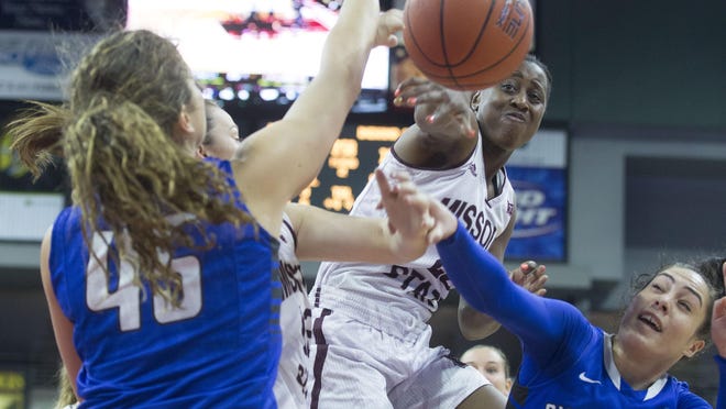 Missouri State’s Tyonna Snow fights for a loose ball with Indiana State’s Ashley Taia, right, and Rhagen Smith during the second round of the MVC tournament on Friday at the iWireless Center in Moline, Ill.