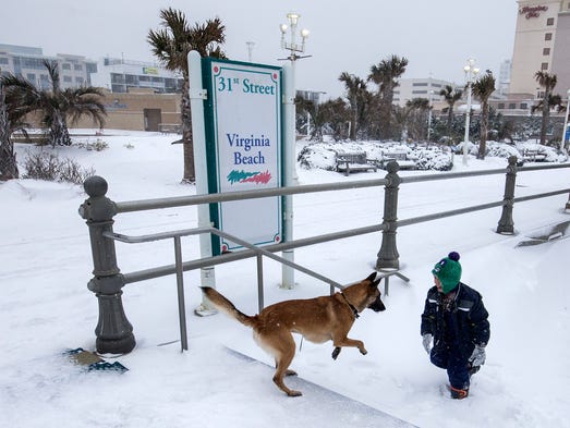 Jayden Willey, 8, plays with a dog named Esco in the