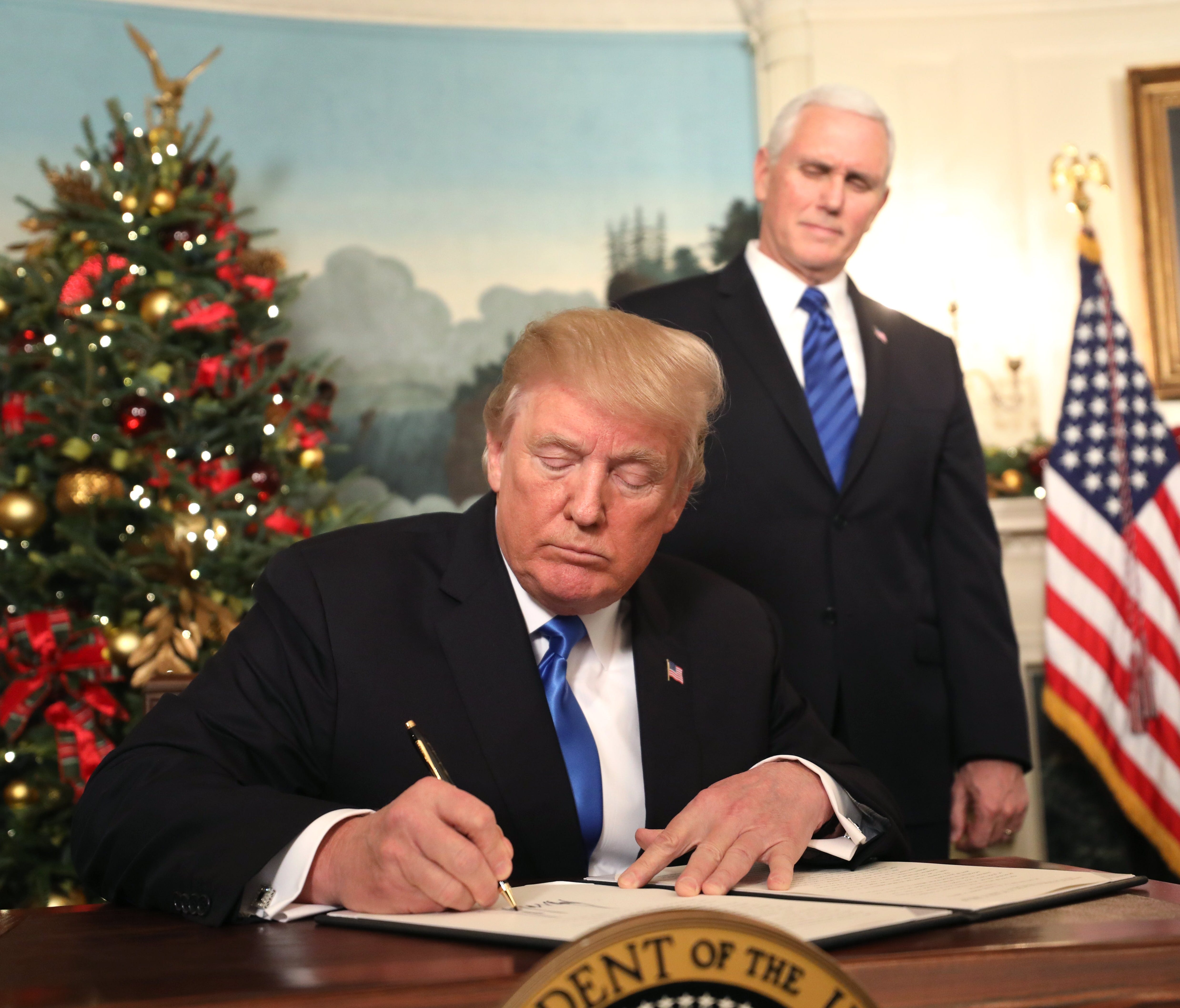 Vice President Pence watches as President Trump sign his proclamation about his decision to recognize Jerusalem as the capital of Israel, and his plan to relocate the U.S. Embassy to that city, in the Diplomatic Room of the White House in Washington,