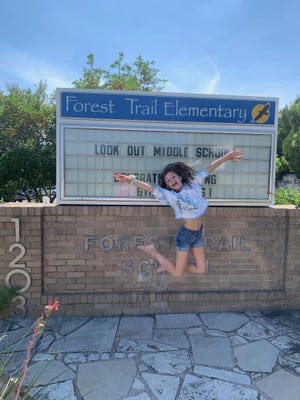 Grace Bates celebrates her graduation from fifth grade at Forest Trail Elementary School. Though in-person school graduation ceremonies couldn't take place amid the coronavirus pandemic, Forest Trail and other Eanes district schools organized car parades for the graduates. Grace and her classmates did a tour of the Lost Creek neighborhood on Friday as neighbors and family members cheered them on. Grace will attend West Ridge Middle School in the fall.