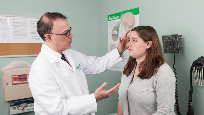 Examining a patient with a history of migraines, Dr. Gary Miller, director of the Headache Center at JFK Neuroscience Institute (within Hackensack Meridian Health JFK Medical Center) in Edison, has specialized in migraine research and treatment for nearly 20 years