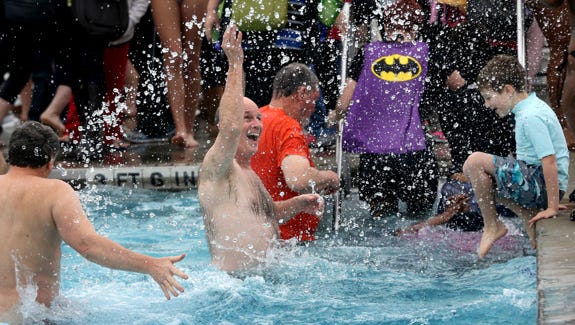 Judge Ben Hall McFarlin Jr., ( center) a judge for the Rutherford County General Sessions Court in Rutherford County splashes around in cold water during a polar bear plunge in the outdoor pool at SportsCom on Saturday Jan. 3, 2014.