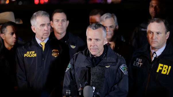 Austin Police Chief Brian Manley stands with other