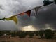 Flags flap in the wind during a monsoon storm in a