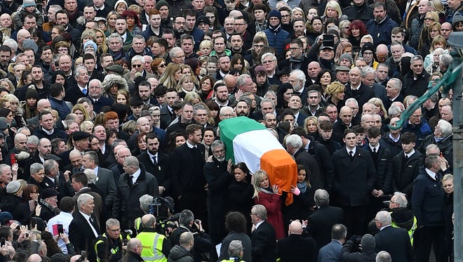 Sinn Fein President Gerry Adams and Sinn Fein Northern Ireland Leader Michelle O'Neill take the part of pallbearers in the funeral procession as they make their way with the coffin to St Columba's Church Long Tower for the funeral of former Northern Ireland Deputy First Minister Martin McGuinness in Derry, Northern Ireland on March 23, 2017.Former Irish Republican Army commander turned peace negotiator Martin McGuinness divided opinion both in life and in death but on Thursday his supporters gave him the funeral of an Irish chieftain.