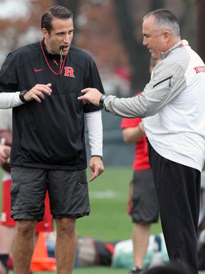 Rutgers football coach Kyle Flood, right, speaks with defensive coordinator Joe Rossi during practice.