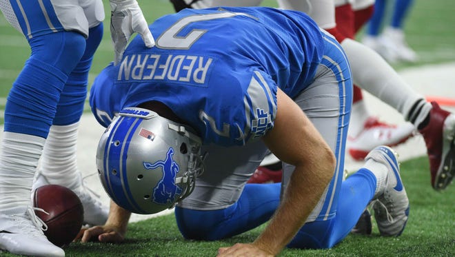 Detroit Lions punter Kasey Redfern reacts after being injured during the first quarter against the Arizona Cardinals at Ford Field.