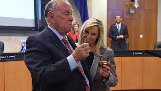 Mayor Bob Cashell gets emotional as he hands incoming mayor Hillary Schieve a personalized gavel and the key to her new office after she was sworn in as mayor during the city council on Nov. 12, 2014.