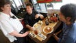 -
Waffle House server Marie Ellis talks with regular