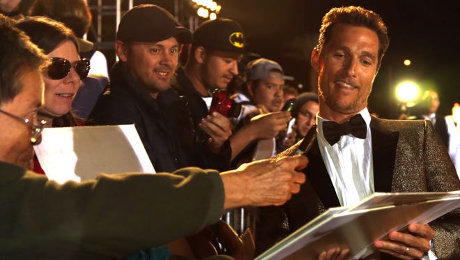 Actor Matthew McConaughey signs for fans during the red carpet arrivals at the 25th annual gala in January. 
Michael Snyder/
The Desert Sun
Actor Matthew McConaughey signs autograph at the 25th annual Palm Springs International Film Festival in January 2014.