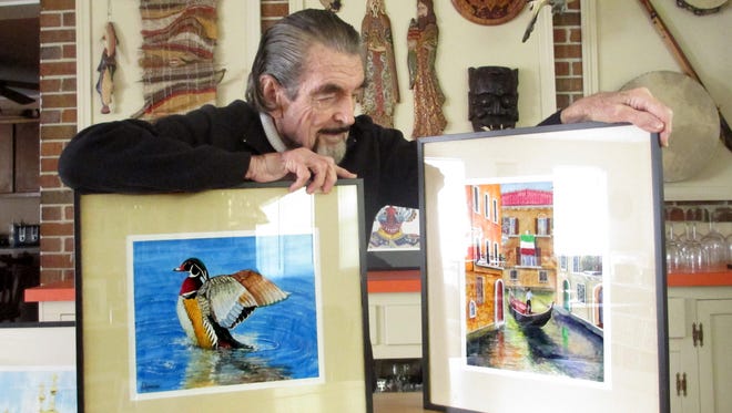 Artist Richard Morrison, 90, poses with some of his work.