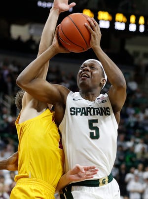 Michigan State guard Cassius Winston (5) shoots as Louisiana-Monroe guard Michael Ertel defends during the second half of an NCAA college basketball game Wednesday, Nov. 14, 2018, in East Lansing, Mich. (AP Photo/Carlos Osorio)