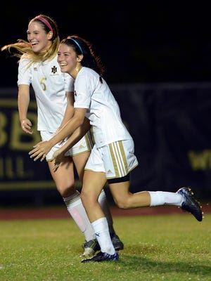 Keli Lindquist (1) and Madison Feeney celebrate Linquist's goal during Friday's regional final.