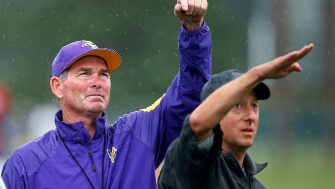 Aug 1, 2016; Mankato, MN, USA; Minnesota Vikings head coach Mike Zimmer (left) gestures with head athletic trainer Eric Sugarman (right) during a weather delay at training camp session at Minnesota State University. Mandatory Credit: Bruce Kluckhohn-USA TODAY Sports