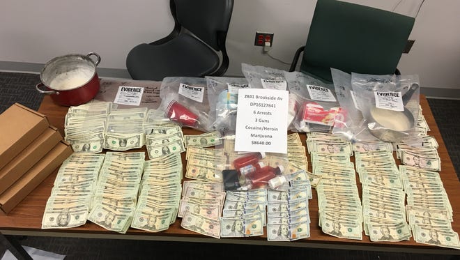 Six men were arrested and drugs, guns and more than $8,000 in cash were seized during a raid at a home in the 2000 block of Brookside Avenue in Indianapolis on Friday, Oct. 21, 2016.