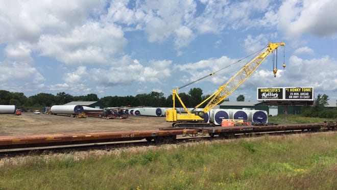 Components for the Black Oak Getty wind project near Sauk Centre are arriving by rail along Minnesota Highway 23 near Rockville. After staging, the pieces are leaving on trucks.