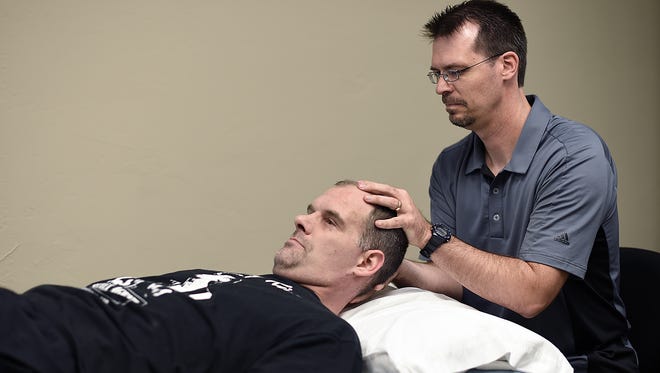 Physical Therapist Shawn Jackson, right, treats Jason Johnson, from Sturgeon Bay, inside ReNew Physical Therapy in Green Bay. Jackson's business got its start at the Advance Business and Manufacturing Center, a business incubator in Green Bay.