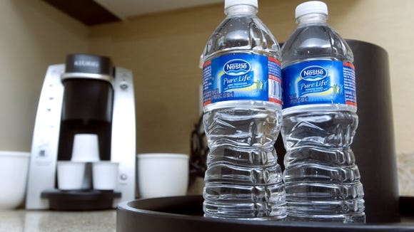 guest using bottled water instead of hotel ice