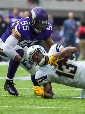 San Diego Chargers wide receiver Keenan Allen (13) carries the ball as Minnesota Vikings cornerback Terence Newman (not pictured) and linebacker Anthony Barr (55) defend during the second quarter in a preseason game at U.S. Bank Stadium.