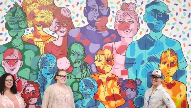 From left, Boys & Girls Club art director Christian Lewis, club CEO Katherine Palmer and Brownwood artist Amanda Coers are pictured in front of a commemorative mural Coers painted in the clubhouse.