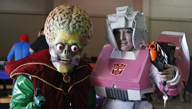 Ryan Wells (left), as the Martian ambassador from "Mars Attacks," and Allysha Butler, a Arcee from "Transformers," pose for a photo at 2014 Cherry City Comic Con. Wells will return as a cosplay guest this year.