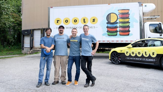 Members of the Roots Hummus crew, from left, Jay Pisaro, project manager, Danny Harvey, facilities supervisor, Michael Porterfield, CEO, and Matt Parris, founder, pose outside of the then-new East Asheville facility in 2018.
(Photo: Angeli Wright/awright@citizen-times.com)