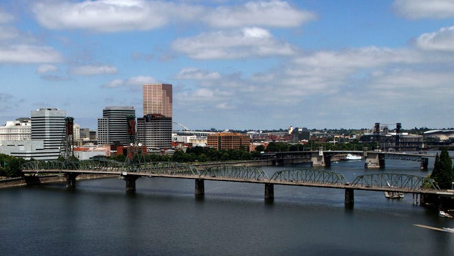 File--In this Aug. 1, 2012, file  photo, several bridges spanning the Willamette River are shown in Portland, Ore. There are numerous bridges in Portland crossing the river, varying in age and ability to withstand a major earthquake.  When North America’s undersea edge and a tectonic plate pushing beneath it inevitably give way to three centuries of accumulated stress, unleashing a monster earthquake and tsunami in the Pacific Northwest, the expected catastrophic loss of life and economic disruptions could be lessened by an early warning system. (AP Photo/Don Ryan, file)