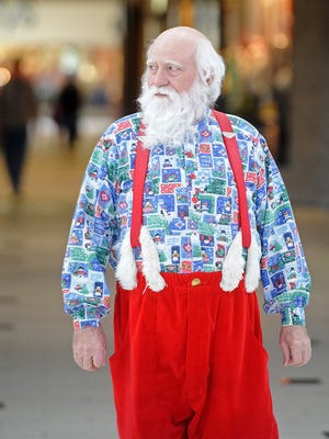 Santa Claus walks through The Empire Mall