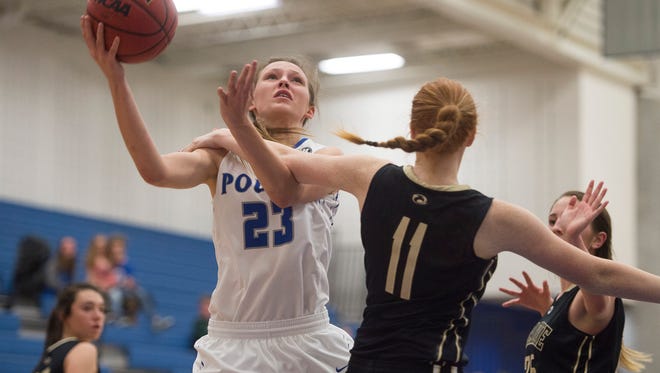 McKenzee Gertz of Poudre High School moves in for a layup around Prairie View defense during the first round of playoffs Tuesday, February 21, 2017. 