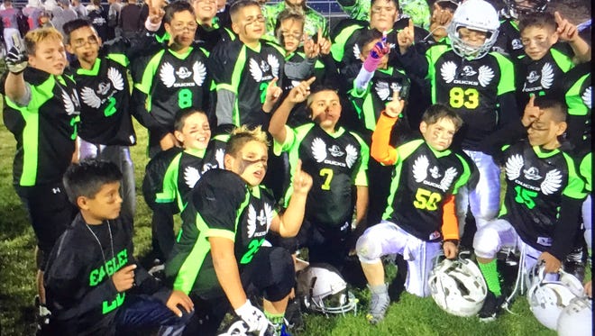 The Ducks celebrate after winning the Super Bowl in the Southwest Youth Football League.