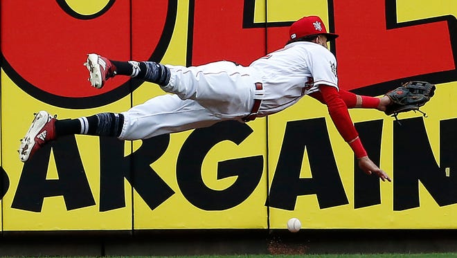 Cincinnati Reds center fielder Billy Hamilton dives for but cannot get to a double off the bat of St. Louis Cardinals' Jose Martinez during the seventh inning of a baseball game, Sunday, April 15, 2018, in Cincinnati. (AP Photo/Gary Landers)