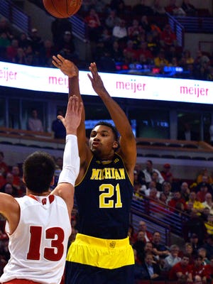 Zak Irvin puts in a shot over the top of Duje Dukan in the first half.
