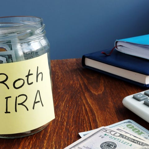 A jar full of money with a note labeled Roth IRA.