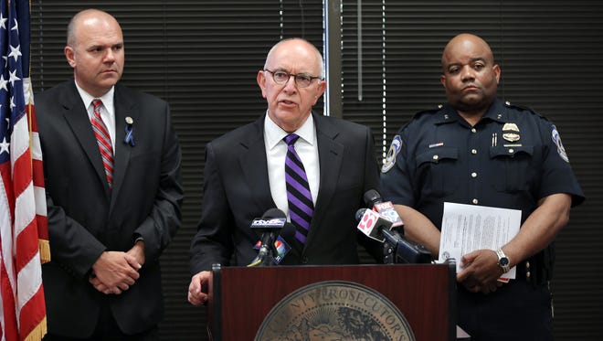 Marion County Prosecutor Terry Curry, flanked by Public Safety Director Troy Riggs and IMPD Chief Rick Hite, announced July 9, 2014, that Major Davis Jr. had been charged with murder in the shooting death of IMPD Officer Perry Renn on July 5, 2014.