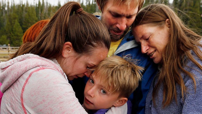 Malachi Bradley, center, is reunited with his family, in Uintah County, Utah, after being lost near a remote mountain lake near the Wyoming border on Sunday.