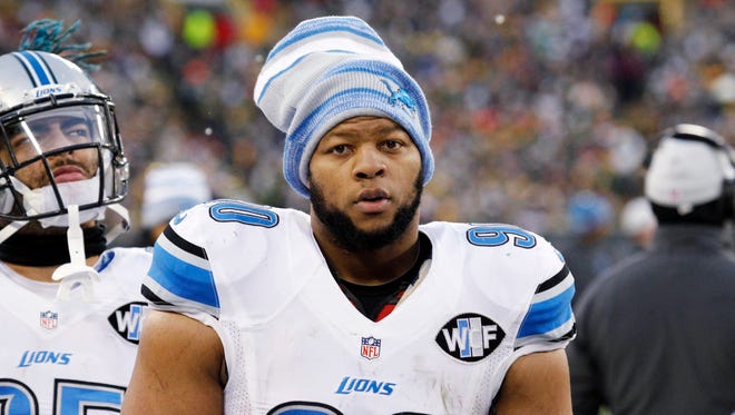 This Dec. 28, 2014 photo shows Detroit Lions' Ndamukong Suh looking on during the first half of an NFL football game against the Green Bay Packers in Green Bay, Wis.